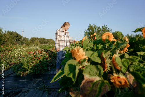 A flower farmer in a plaid shirt