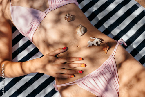Seashells on a woman's belly and skin photo
