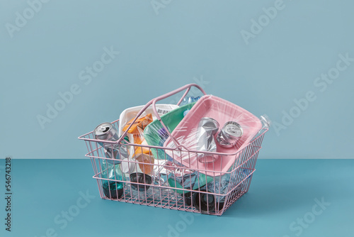 Various waste inside wire basket. photo