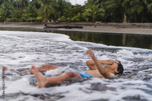 Child playing with the waves. photo