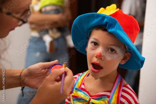 Little boy transforms into evil clown at halloween party photo