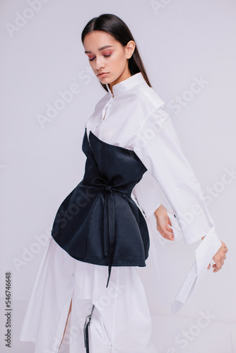 Pretty woman in white shirt dress  and black corset 
