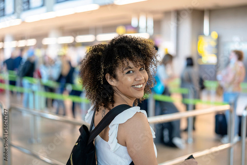 Happy black woman waiting for flight photo