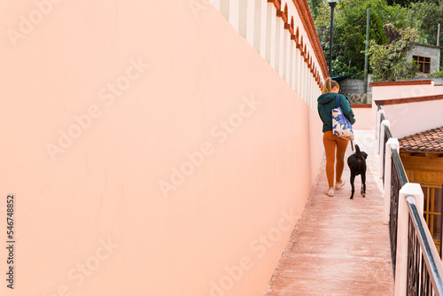 Woman walking with her dog in a town photo