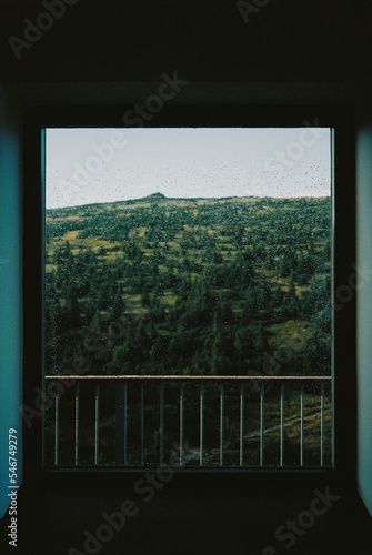 Green Mountain Landscape Through Window With Rain Drops