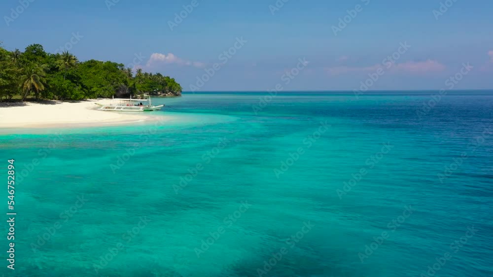 White sandy beach with palm trees.Tropical island on a coral reef, top view. Turquoise lagoon with clear sea water. Mahaba Island, Philippines. advertising concept White sandy beach with palm trees.Tropical island on a coral reef, top view. Turquoise lagoon with clear sea water. Mahaba Island, Philippines. advertising concept