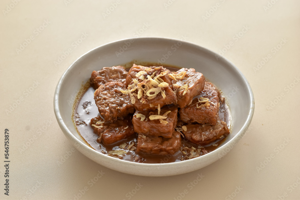 Semur Tempe or Tempeh stew, family favorite dish. Has a sweet and savory taste. Tempeh cooked with soy sauce, then served with a sprinkle of fried onions.