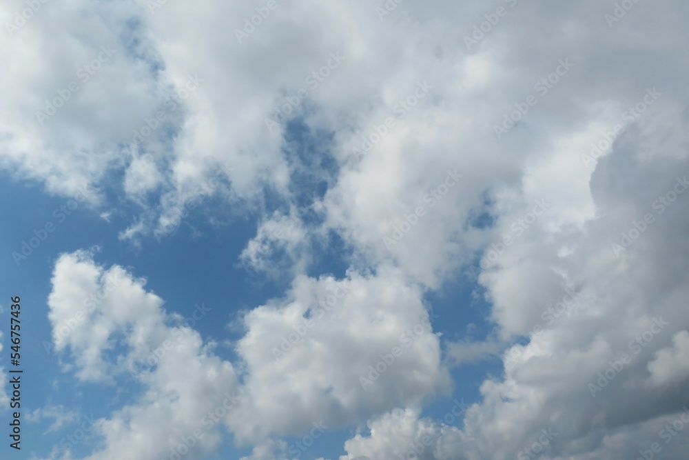 Beautiful fluffy clouds in the blue sky, natural background Beautiful fluffy clouds in the blue sky, natural background