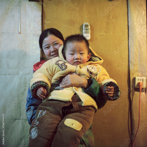 Women holding drowsy children photo