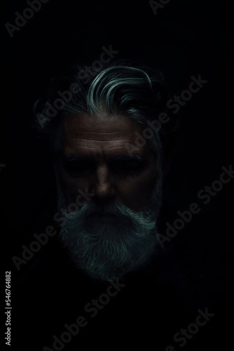 Senior man portrait in a shadow photo