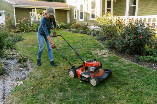 woman starting up her lawnmower