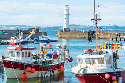 Fishing boats in Newhaven harbour,with Lighthouse behind,Edinburgh,Scotland,UK. photo
