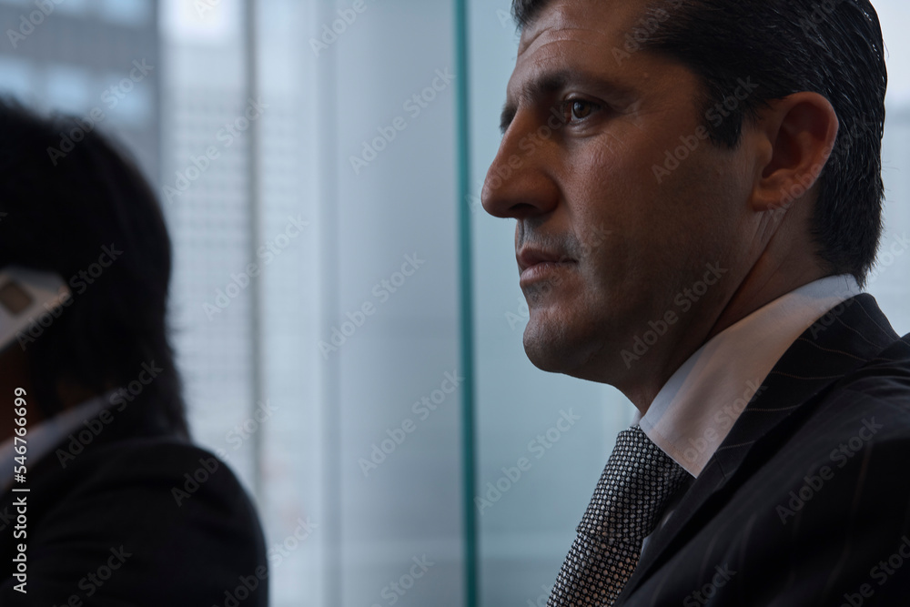 Portrait of a businesman sitting near an hotel window Portrait of a businesman sitting near an hotel window