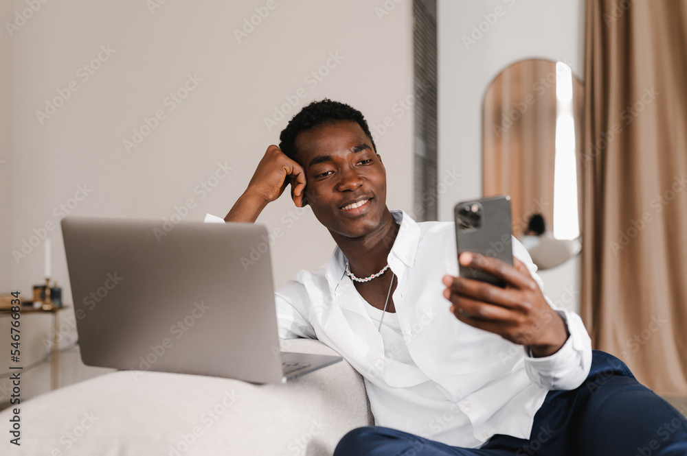 Glad freelancer using cellphone during break Glad freelancer using cellphone during break