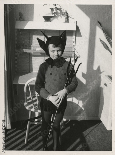 young girl dressed up in devil costume photo