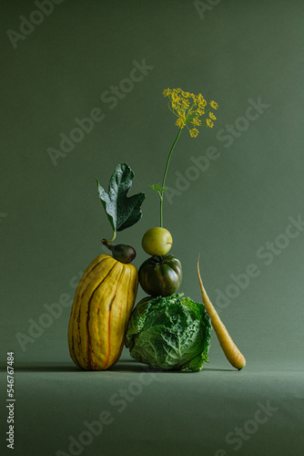 Still life of vegetables on green background photo