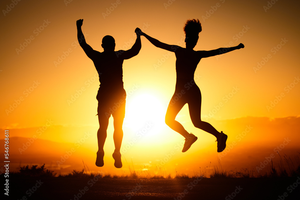 Sunset, jump and view with a sports couple outdoor in nature for a workout, fitness or exercise together. Silhouette, motivation and health with a man and woman jumping in celebration of a goal