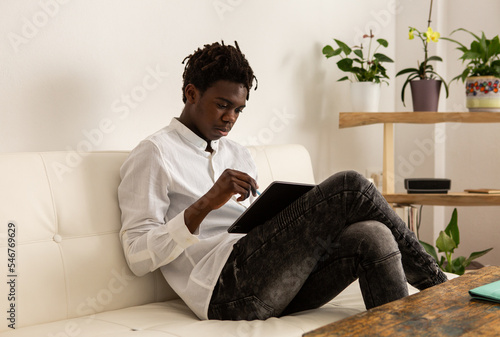 Young man using a tablet for drawing photo