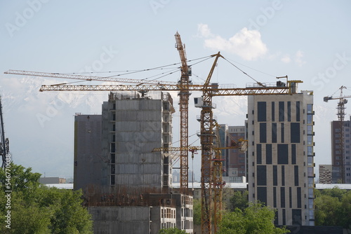 Almaty, Kazakhstan - 04.26.2022 : Construction of a high-rise residential complex near a road junction. photo