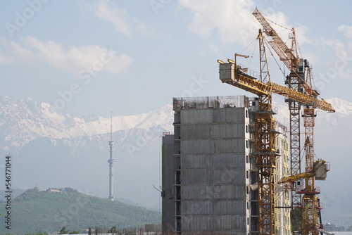 Almaty, Kazakhstan - 04.26.2022 : Construction of a high-rise residential complex near a road junction. photo