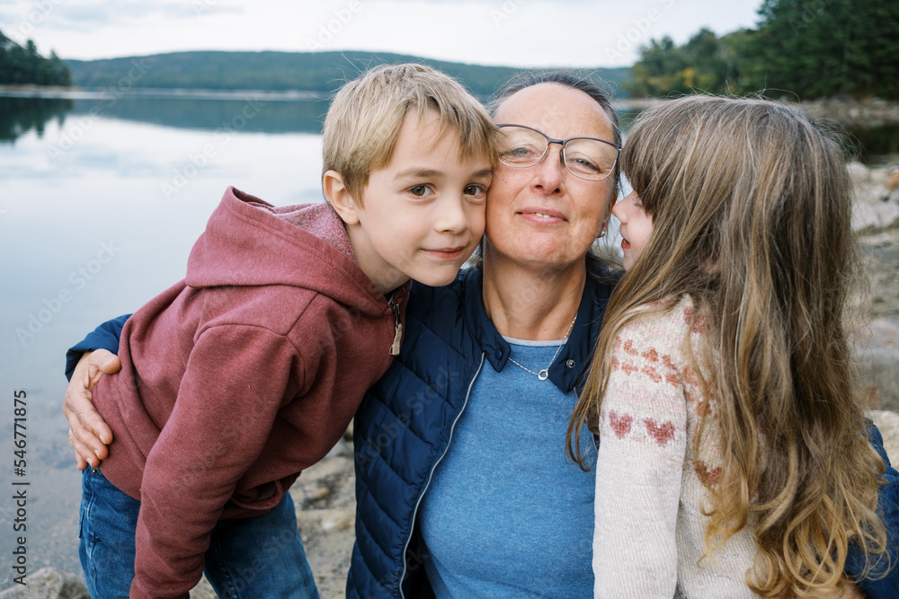 Grandmother with her grandchildren by the shore Grandmother with her grandchildren by the shore