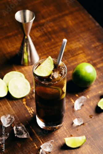Photography Cuba libre cocktail cold and refreshing drink for summer days on a wooden table