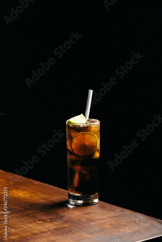 Canvas Print Cuba libre cocktail cold and refreshing drink for summer days on black backgroun