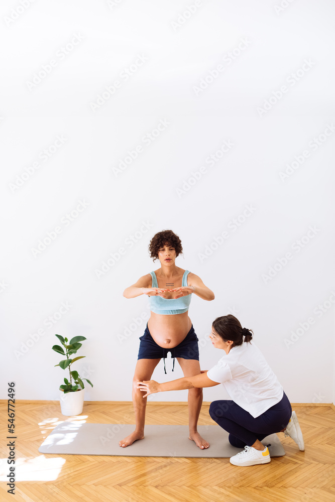 Pregnant Woman Doing Yoga with Instructor Pregnant Woman Doing Yoga with Instructor