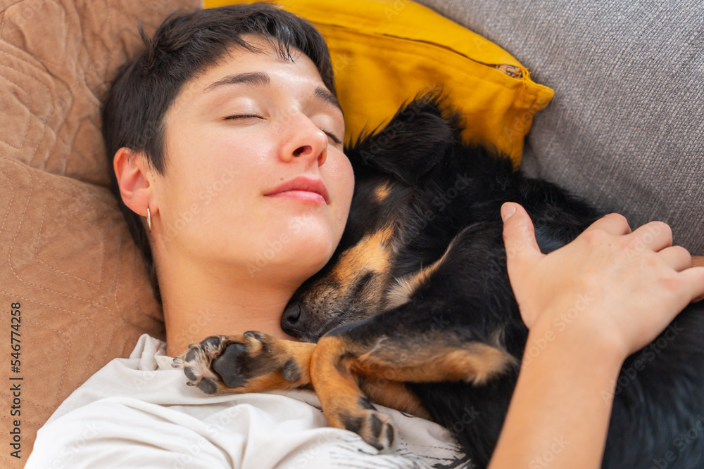 Woman Sleeping With Her Dog On The Couch. Woman Sleeping With Her Dog On The Couch.