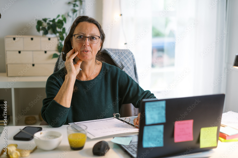 middle-aged woman working in home office middle-aged woman working in home office