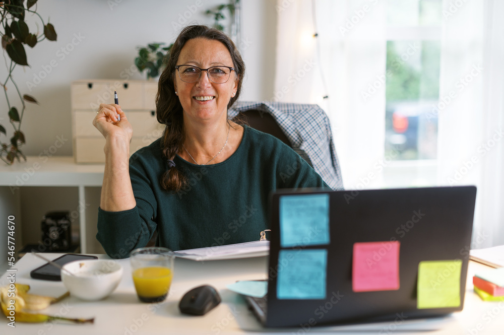 middle-aged woman working in home office middle-aged woman working in home office
