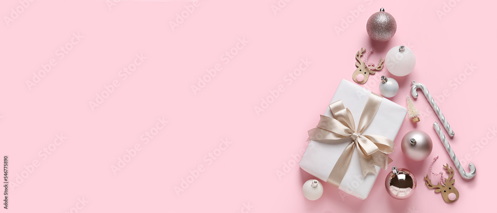 Christmas tree made of decorations and gift on pink background with space for text