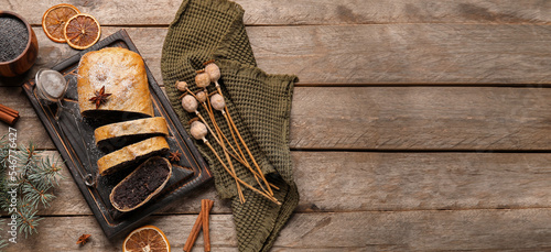 Tasty poppy seed strudel on wooden background with space for text