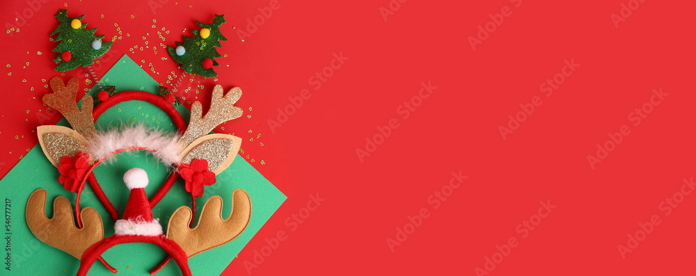 Funny Christmas deer horns on red background with space for text