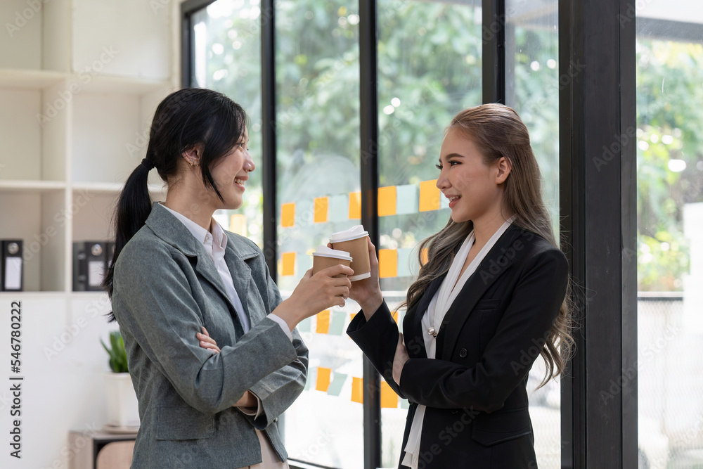 Diverse employees chatting during coffee break, walking in modern office, Asian businesswoman wearing glasses sharing ideas, discussing project with colleague, having pleasant conversation Diverse employees chatting during coffee break, walking in modern office, Asian businesswoman wearing glasses sharing ideas, discussing project with colleague, having pleasant conversation
