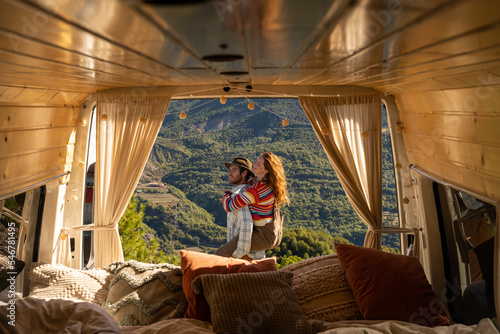 Happy couple with camper van in nature photo
