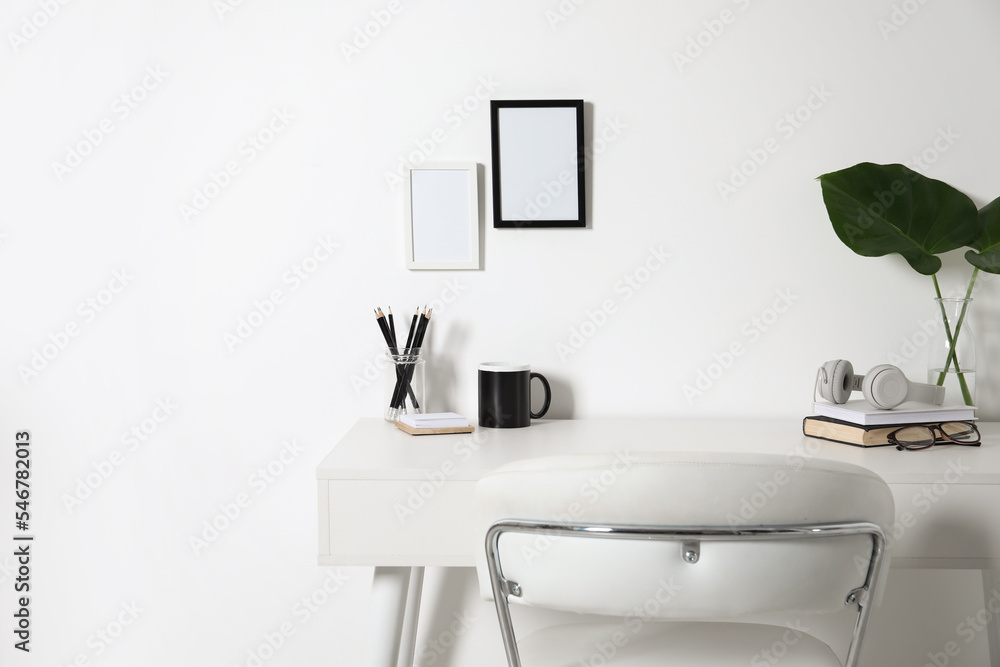 Comfortable workplace with white desk near wall at home Comfortable workplace with white desk near wall at home