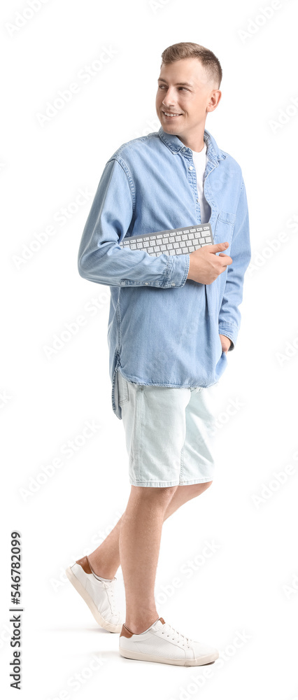 Young man with computer keyboard on white background Young man with computer keyboard on white background
