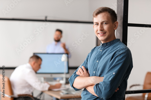 Young bank manager smiling in office