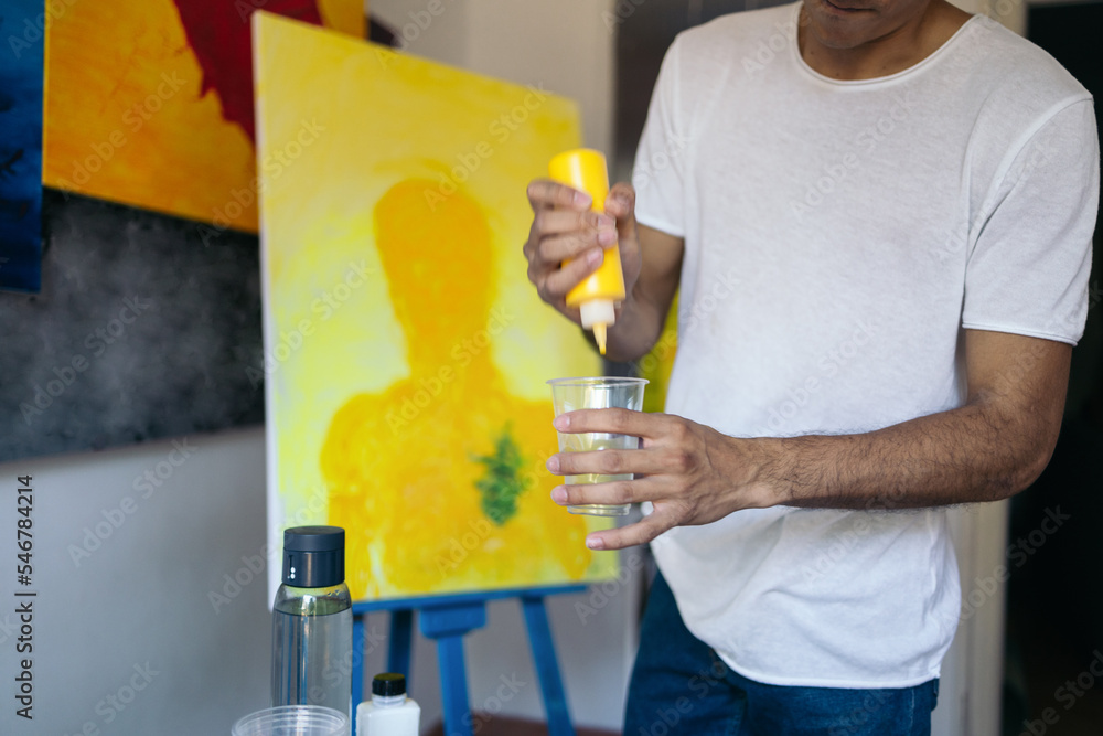 Young artist preparing his materials to paint a picture on canvas Young artist preparing his materials to paint a picture on canvas