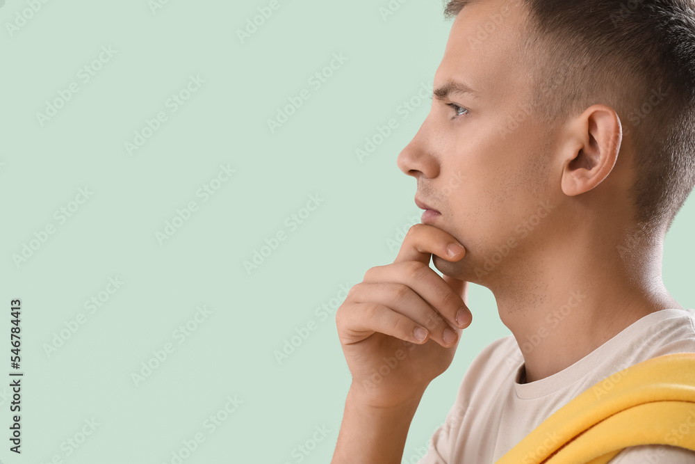 Thoughtful young man on green background, closeup Thoughtful young man on green background, closeup
