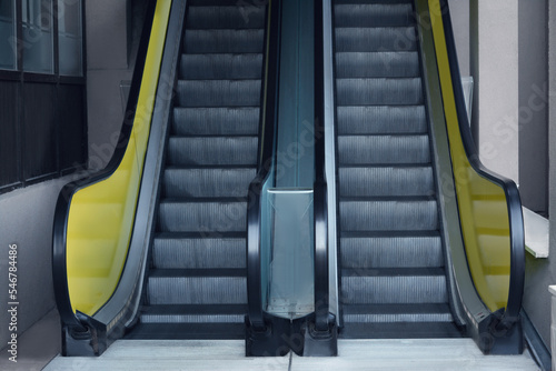 Fotografering View on empty parallel escalators with yellow balustrades
