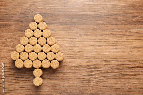 Christmas tree made of wine corks on wooden table, top view. Space for text