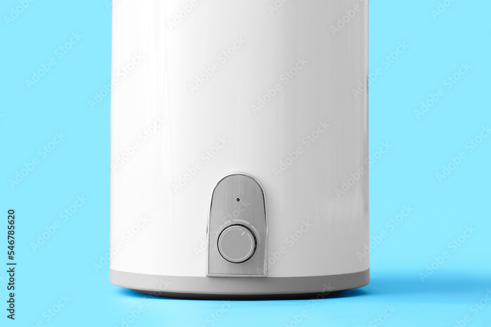 Modern electric boiler on blue background, closeup Modern electric boiler on blue background, closeup