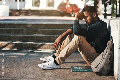 Education, fail and stress with a black man student worried about an exam or test on university campus. College, sad and scholarship with a male pupil feeling depressed after a negative report