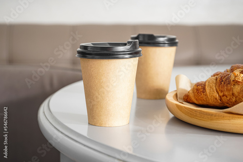 Paper cups with drink on ta...