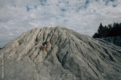 Child slides off the marble mound