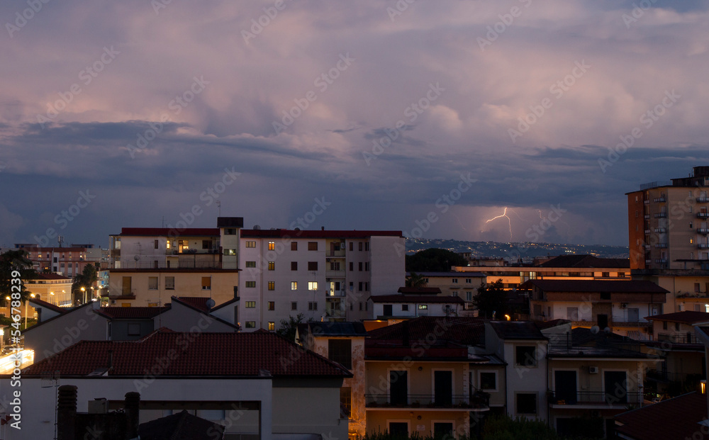 panoramica city skyline of Aversa in bad weather with clouds and thunder lightning