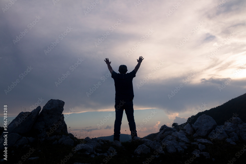 hiker on the mountain summit at sunset in the Matese park