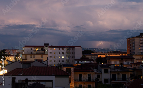 panoramica city skyline of Aversa in bad weather with clouds and thunder lightning